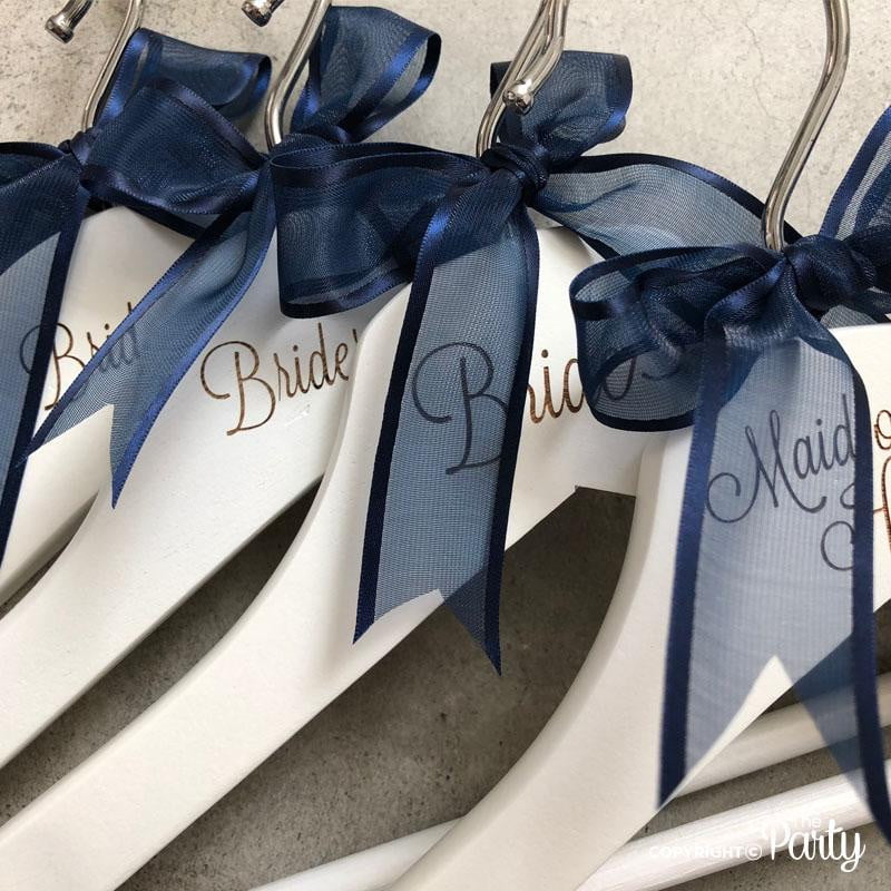 Set of 2 adult size engraved white wooden hangers – The Party, Dubai